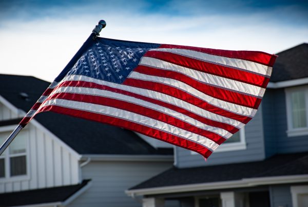 American Flag with VA Homes behind it