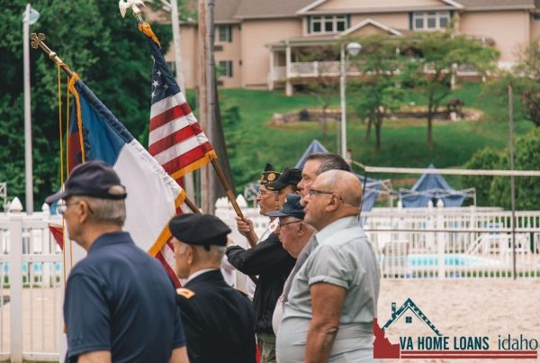 Veterans standing in a line with two flags